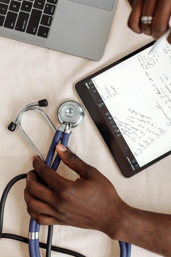 direct primary care doctor reviewing patient data with stethoscope and notes on desk