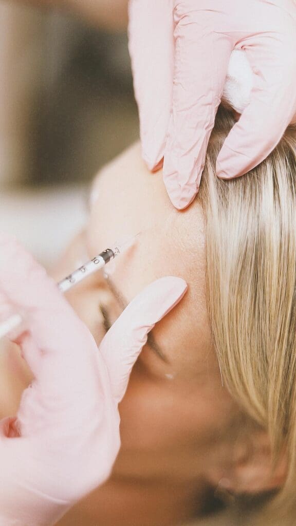 Medical professional performing Botox injections on patient in clinical setting for botox reno treatment