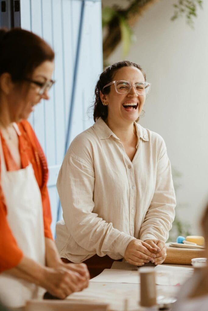 A happy, energetic mid-aged woman laughing and enjoying time outside with friends after finding balance through hormone replacement therapy in Reno.